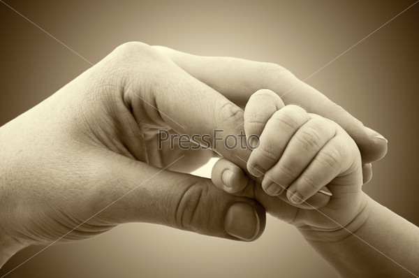 concept of love and family. hands of mother and baby closeup