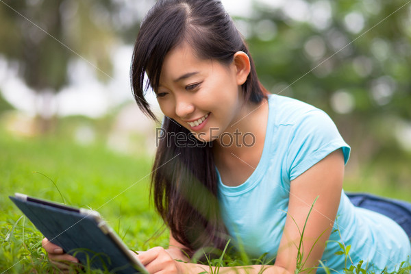 Happy student preparing for lessons in the park