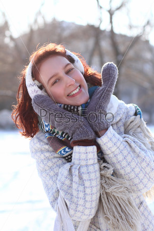 Sweet winter girl in the park outdoors