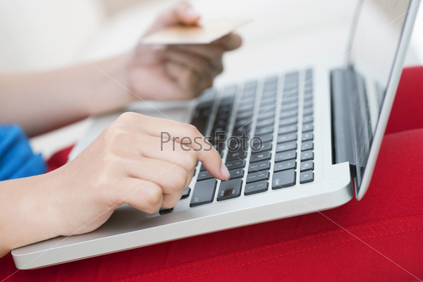 Young female being about to press the enter key and confirming her online order