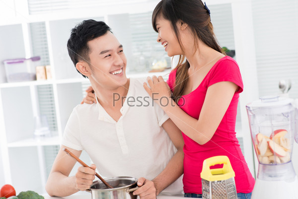 Young couple having fun cooking together
