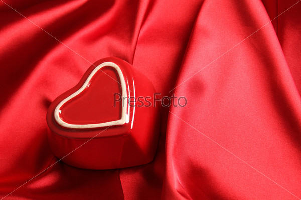 On a red silk fabric is a red heart