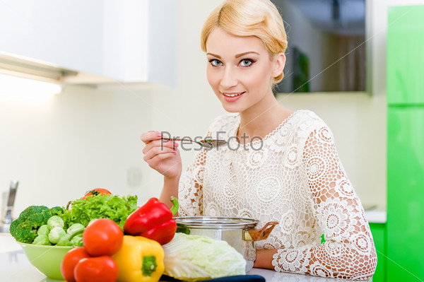 Young woman tasting soup.Healthy Vegetarian Food. Dieting Concept. Healthy Lifestyle. Cooking At Home.