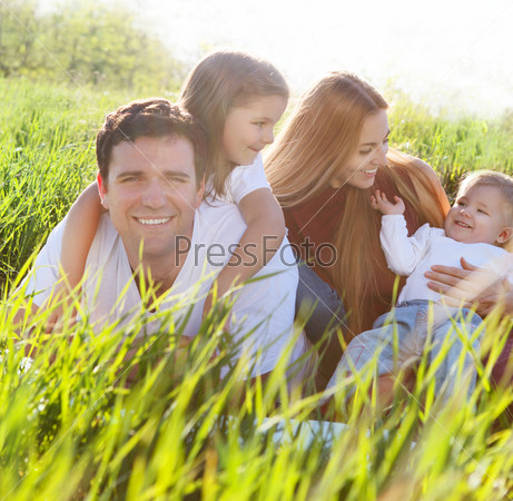 Happy Young Family With Two Children Outdoors