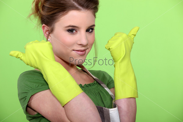 Young women wearing rubber gloves and apron