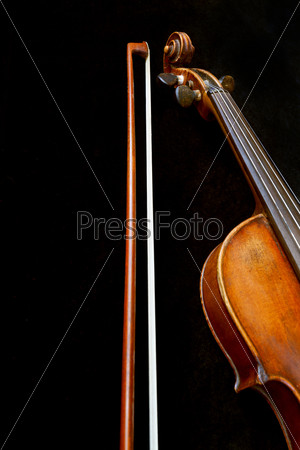 violin neck and bow on black background close up