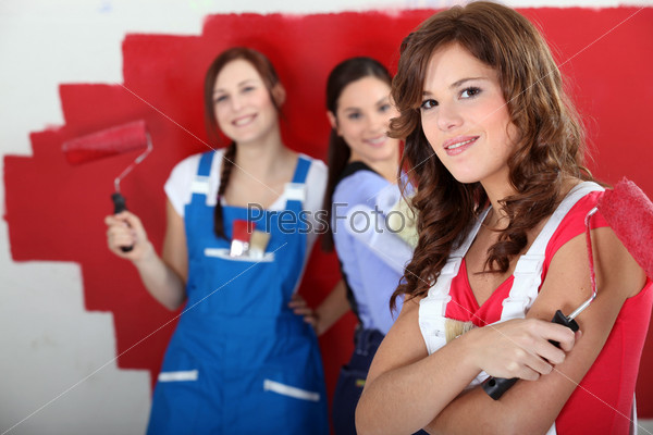 trio of handy girls painting room red