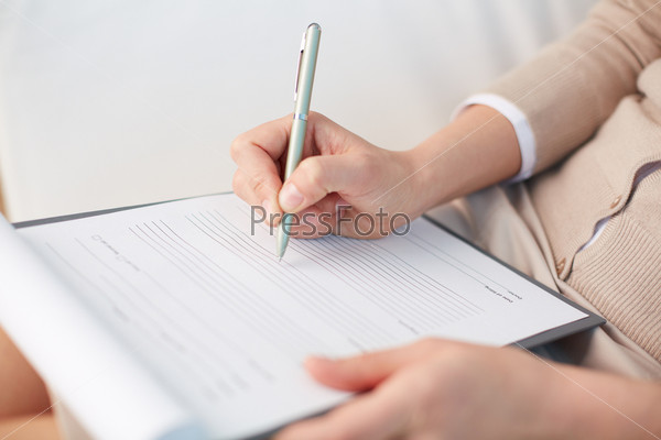 Female counselor writing down some information about her patient
