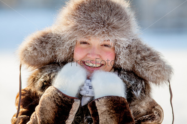happy young girl in a fur hat