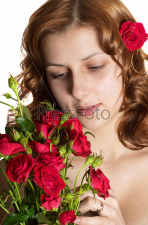 pretty green-eyed girl with a bouquet of red roses on a white background isolated