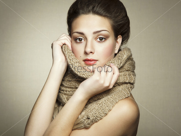Portrait of a beautiful young woman with scarf. Fashion photo