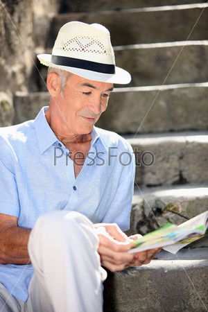 old man reading magazine