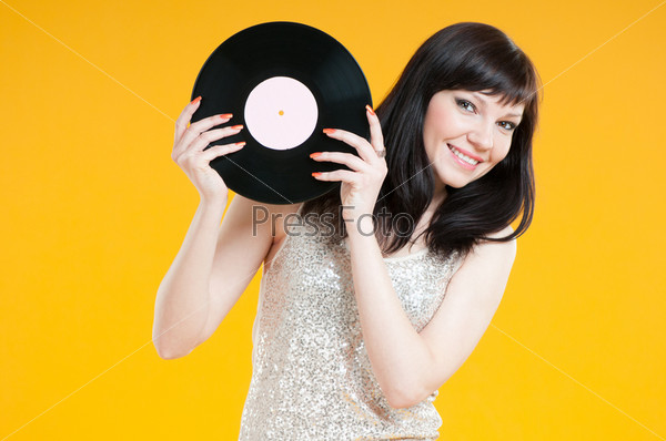 Studio shot of smiling caucasian female with a vinyl record