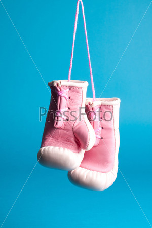 Souvenir pink boxing gloves isolated on blue
