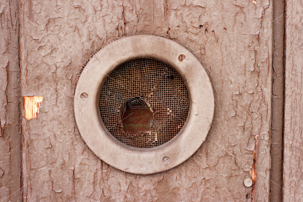 Round hole in the wooden wall