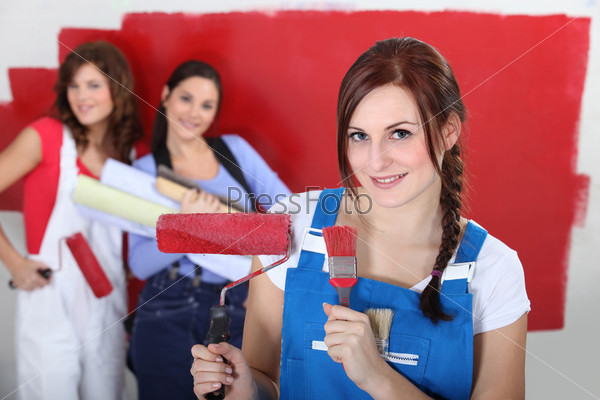 Women painting a room red