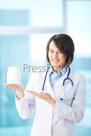 Portrait of a female doctor presenting new pills