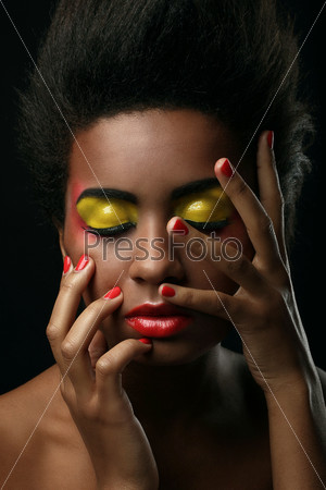 Beautiful black woman with glossy makeup isolated over black background