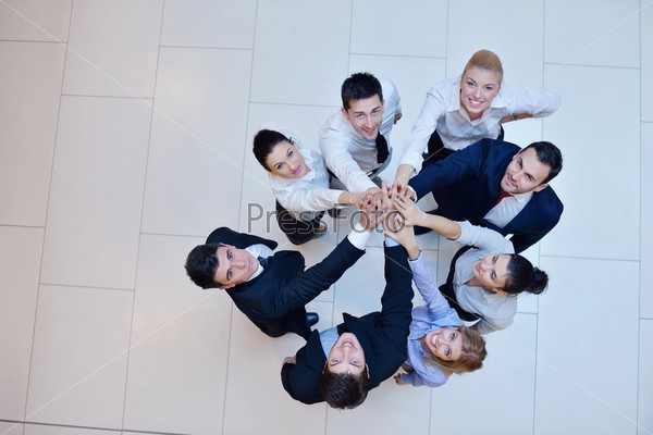 business people group joining hands and stay as team in circle  and representing concept of friendship and teamwork