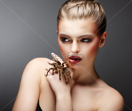 Beautiful Girl Holding Live Tamed Spider in her Hand. Pet