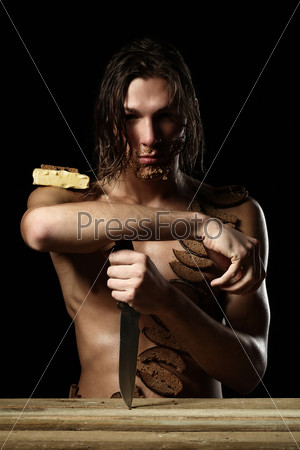 Art photo of young man with beard of bread isolated over black background