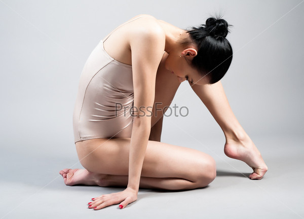 The young beautiful gymnast on training. The master of sports, stock photo