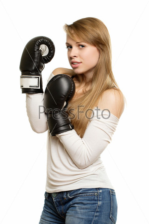 Playful young woman with black boxing gloves. Isolated on white