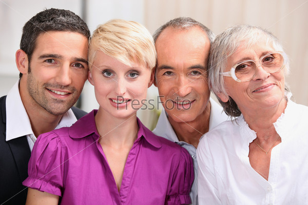 60 years old man and woman posing with 30 years old man and woman