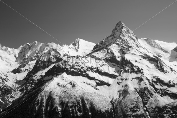 Mountains with snow in winter. Winter landscape. View of the snow mountain peak