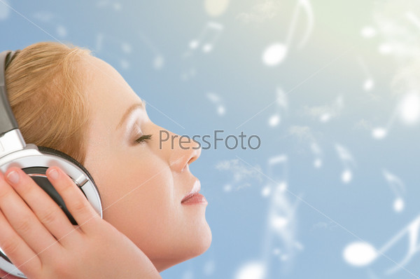 musical concept. woman with headphones relax, enjoy the music on the sky background with notes
