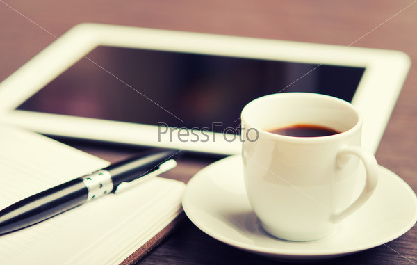 Workplace, office desk: coffee and tablet pc and notebook with p