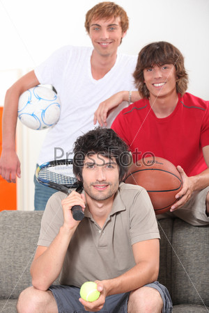 Three male friends with various sporting equipment