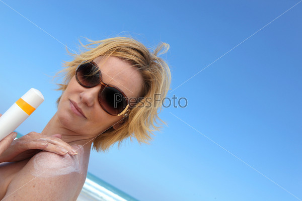 Woman applying sun cream