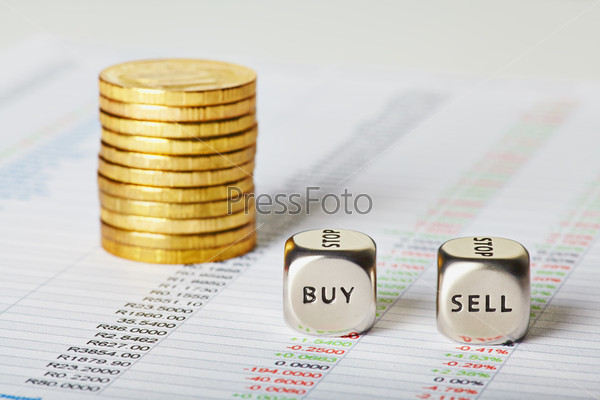 Financial charts, golden coins and dice cubes with words Sell Buy. Selective focus