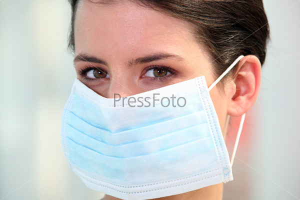 Nurse wearing surgical mask, stock photo