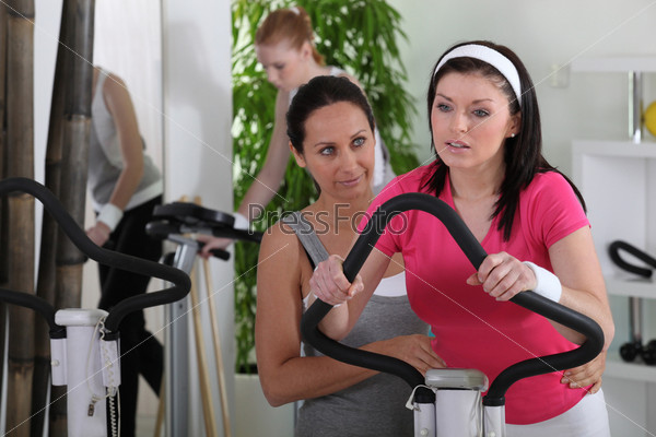 Female riding a bike in the gym, stock photo