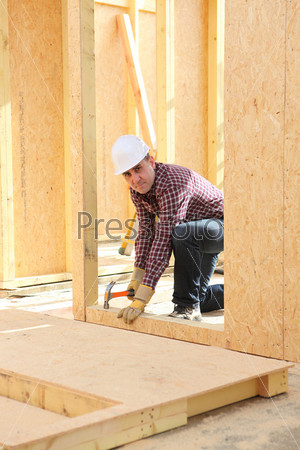 Builder constructing a house