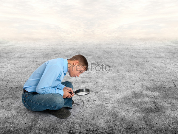 young man looking through a magnifying glass