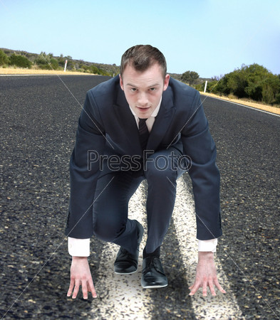 Competitive business man about to run, stock photo