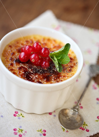 Creme brulee (cream brulee, burnt cream) with red currant and mint