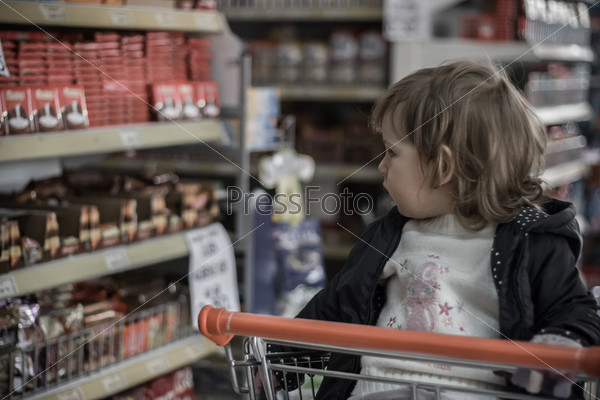 Little Girl on a Market on a Shopping Chart, stock photo