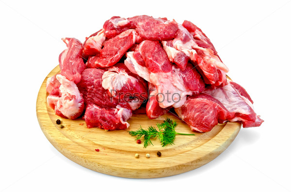 Cuts of meat, dill, pepper pots of different on a round wooden board isolated on white background, stock photo