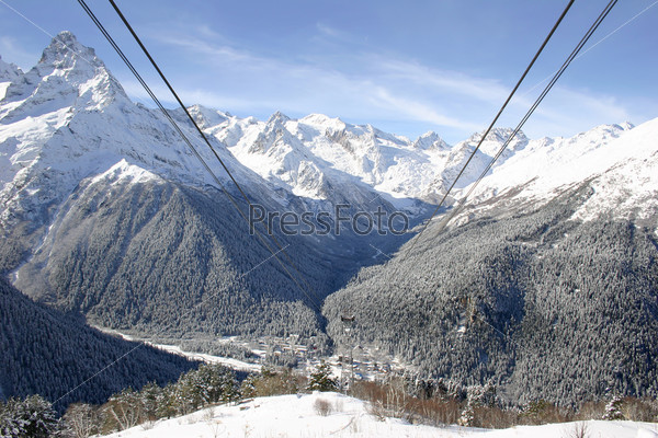 Panorama from the white mountains and ski lift cables