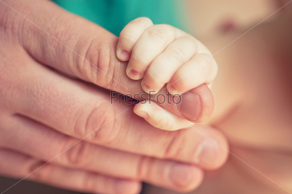 small child holding the handle of the mother