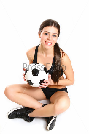 Sexy girl is sitting with a soccer ball on white background from above