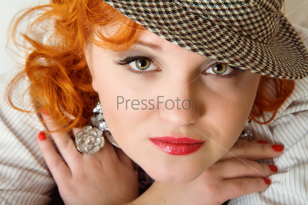 beautiful young woman with red curly hairs wearing fedora hat