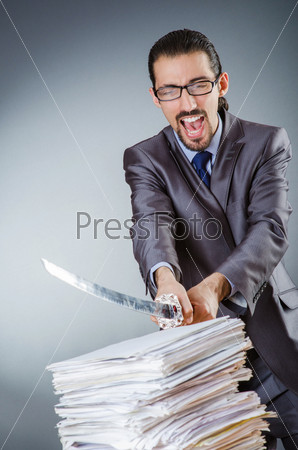 Businessman cutting the pile of paper
