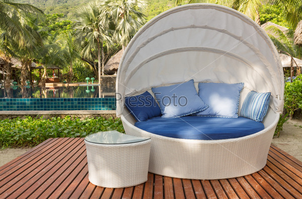 Nice cozy white round chair with canopy and blue cushions