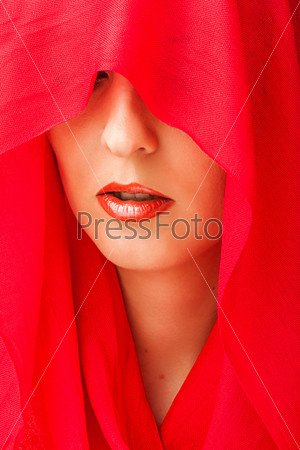 Portrait of sensual woman model with sexy makeup on lips and covered eyes by red  scarf