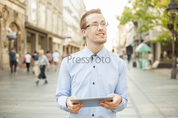 Businessman Man Using Tablet Computer in public space, street, city